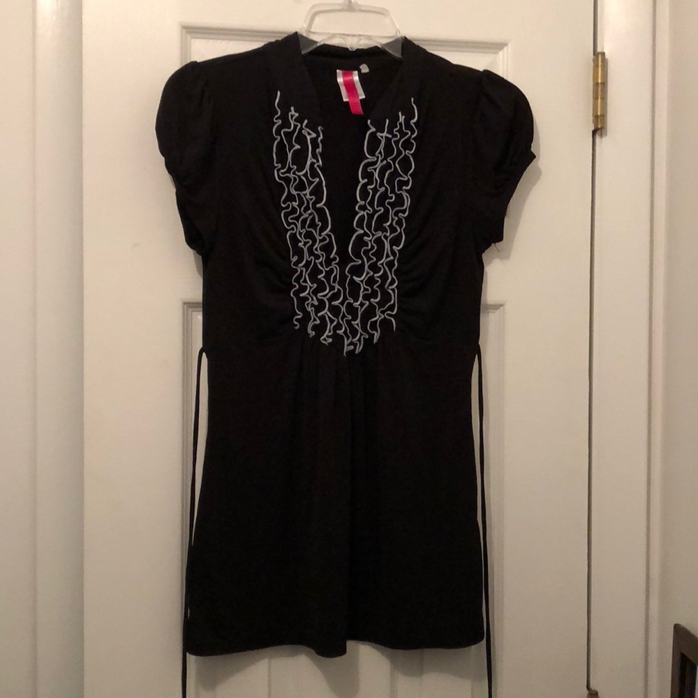 Black shirt with ruffles.